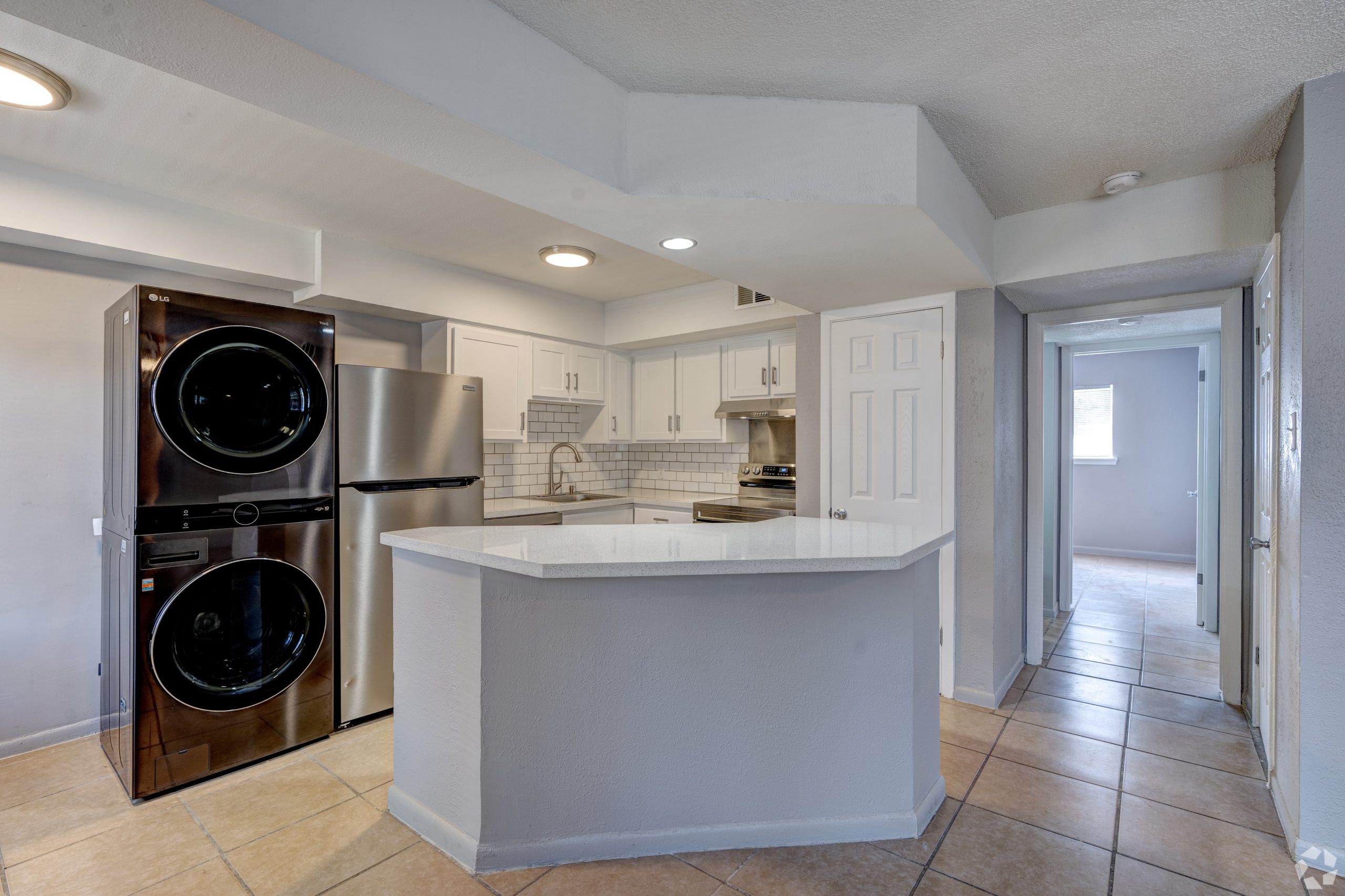 a kitchen with a washer and dryer in it at The Westview Pines