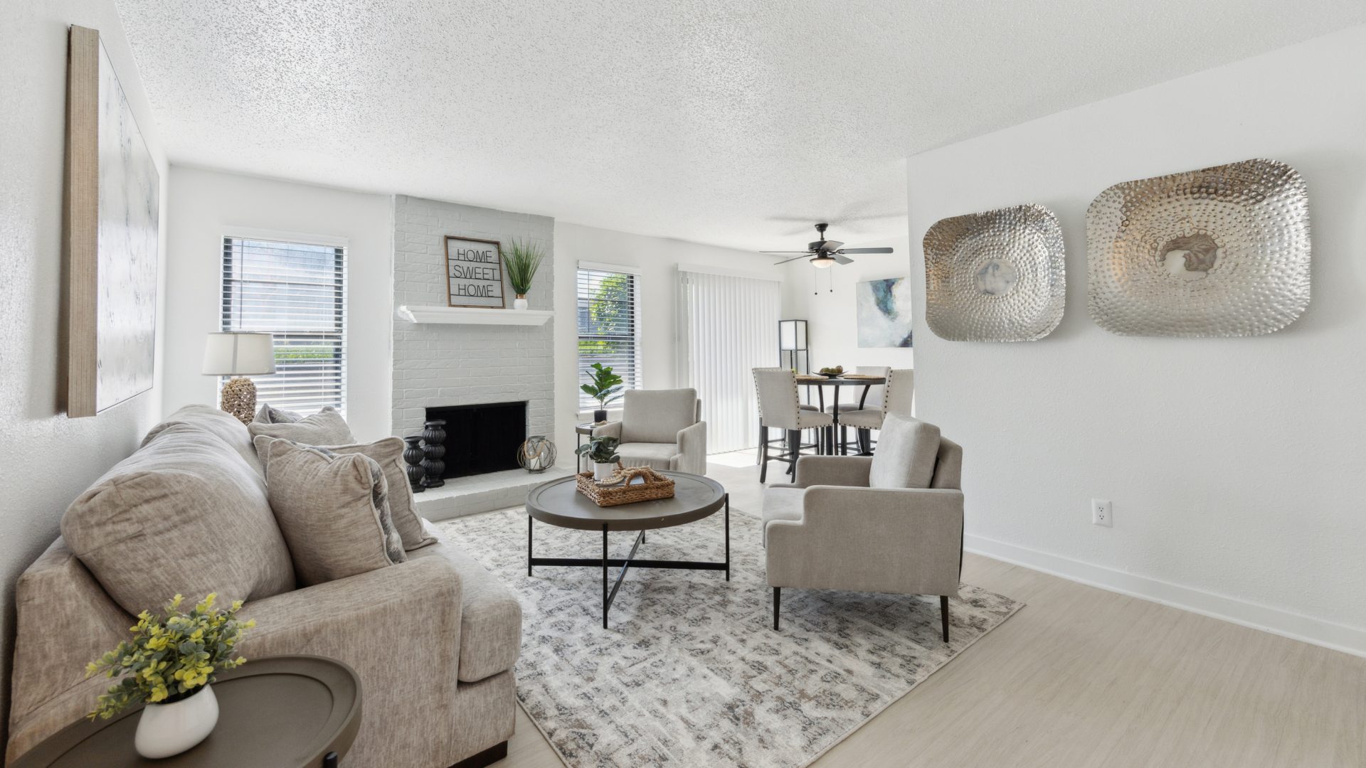 a living room with white walls and a fireplace at The Brookbend