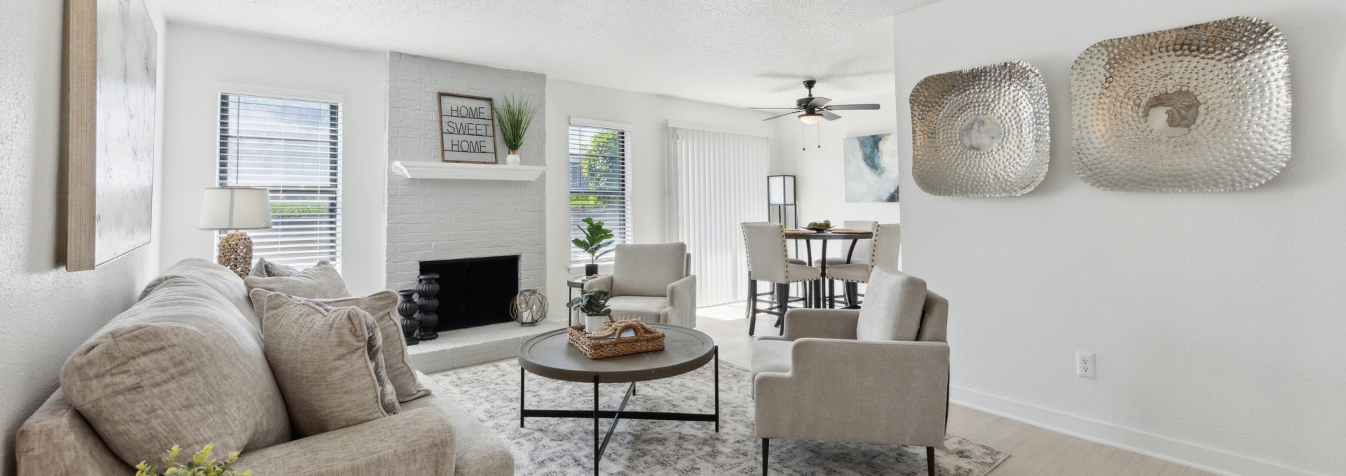 a living room with white walls and a fireplace at The Brookbend