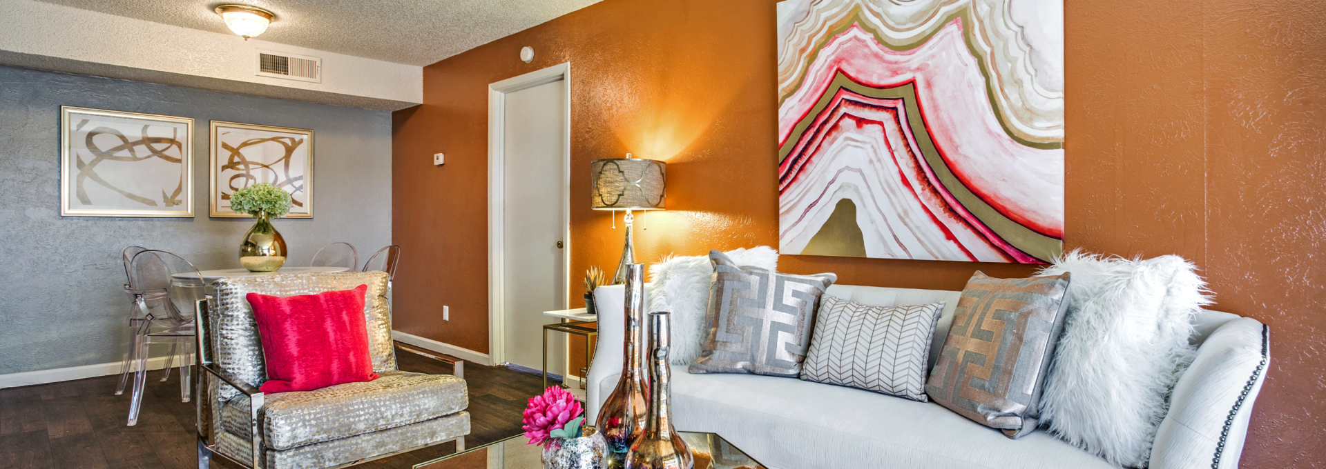 a living room with orange walls and white furniture at The  Hive