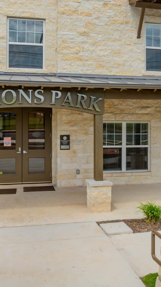 the front entrance to baron park apartments in austin, texas at The Barons Park