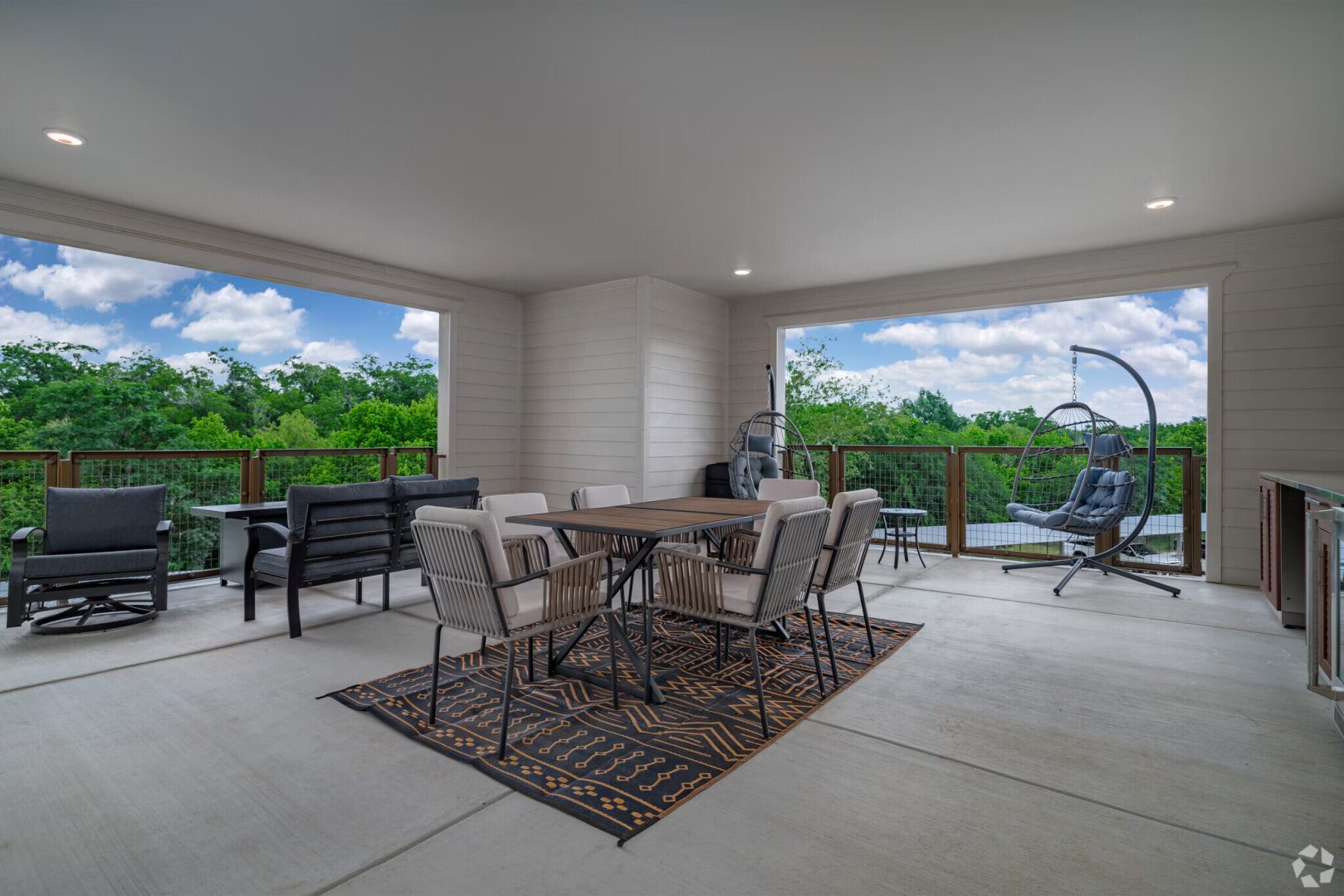 a patio with a table and chairs and a grill at The Barons Park