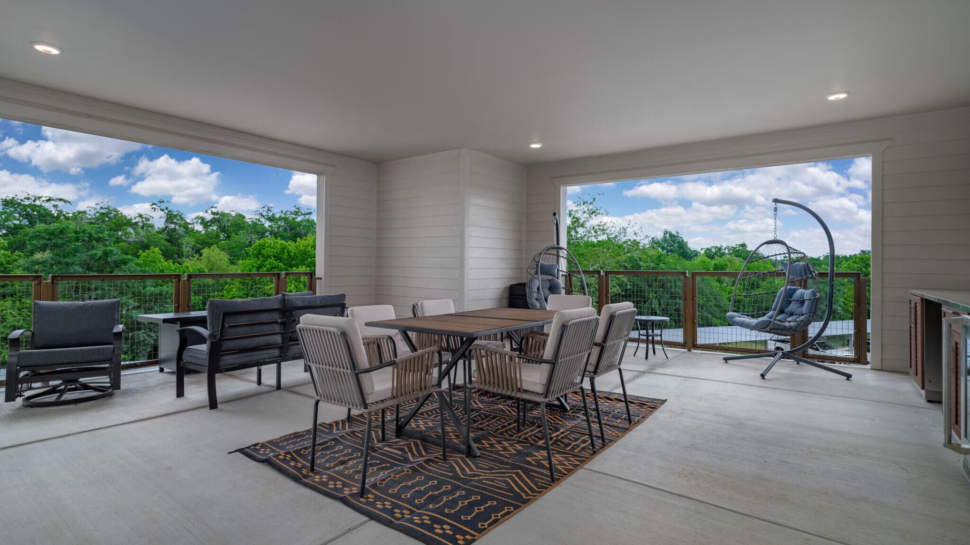 a patio with a table and chairs and a grill at The Barons Park