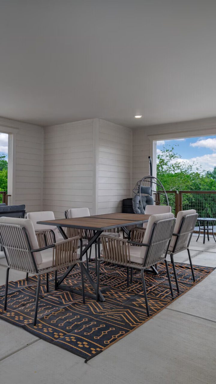 a patio with a table and chairs and a grill at The Barons Park