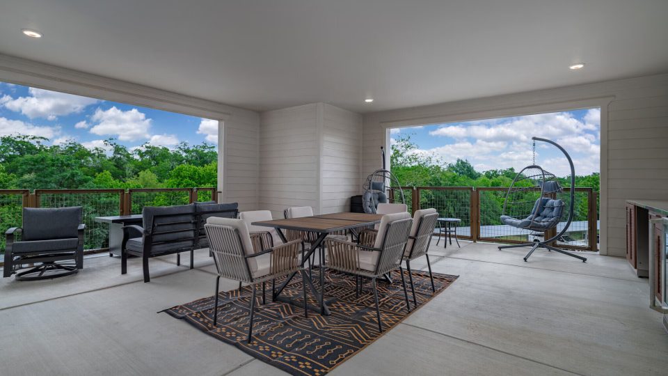 a patio with a table and chairs and a grill at The Barons Park