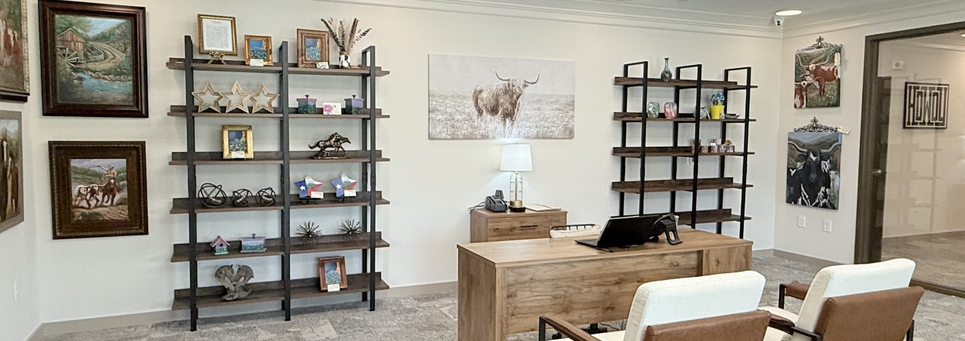 Leasing Office with desk, book shelves, and chairs