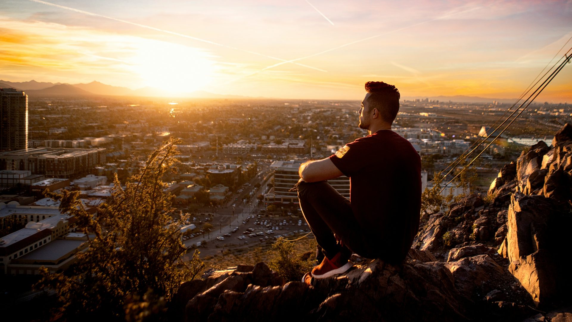 Lifestyle photo of golden hour photography of man sitting on rock