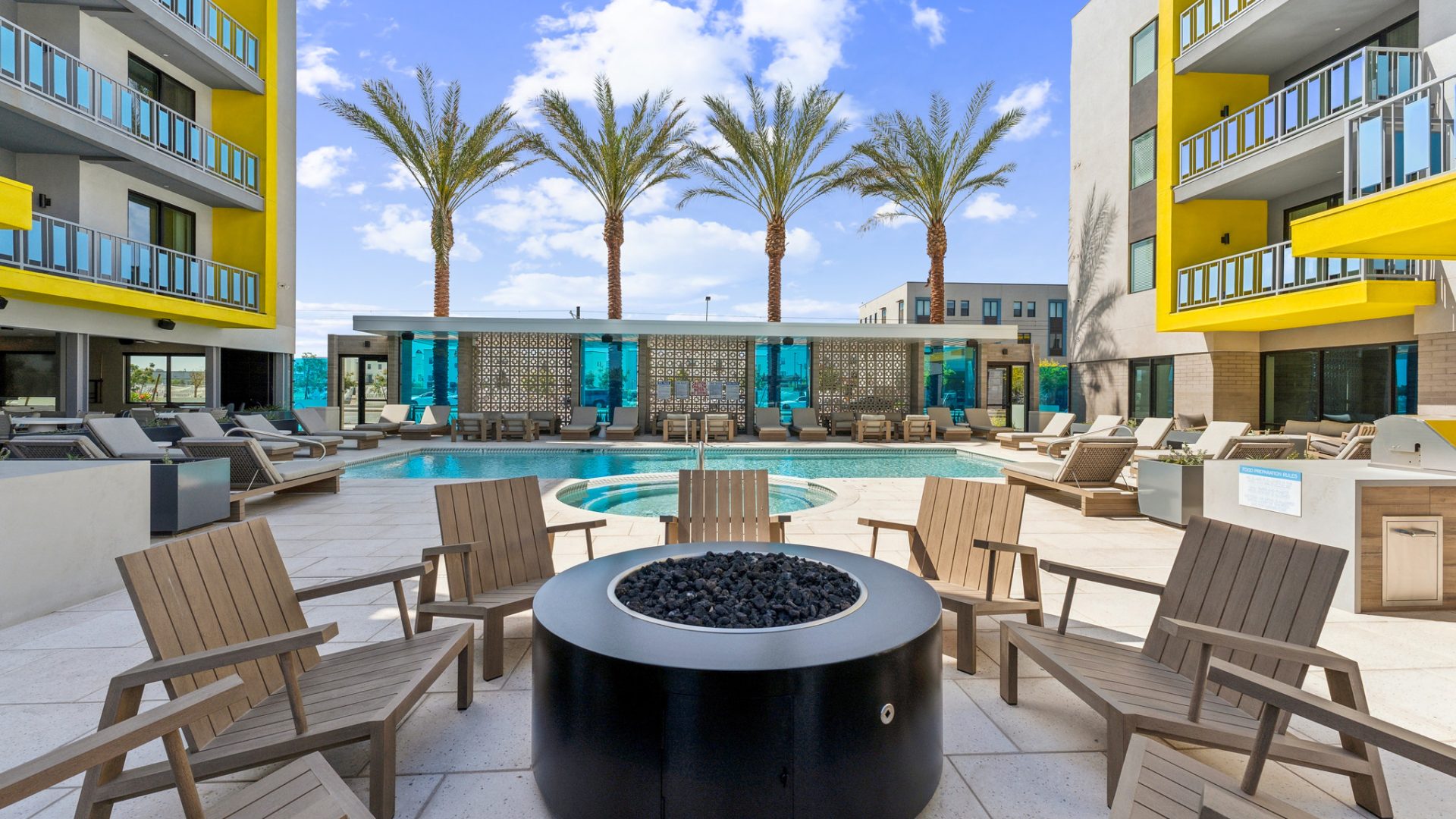 Community firepit and sparkling pool in Blue Eastline's apartment complex