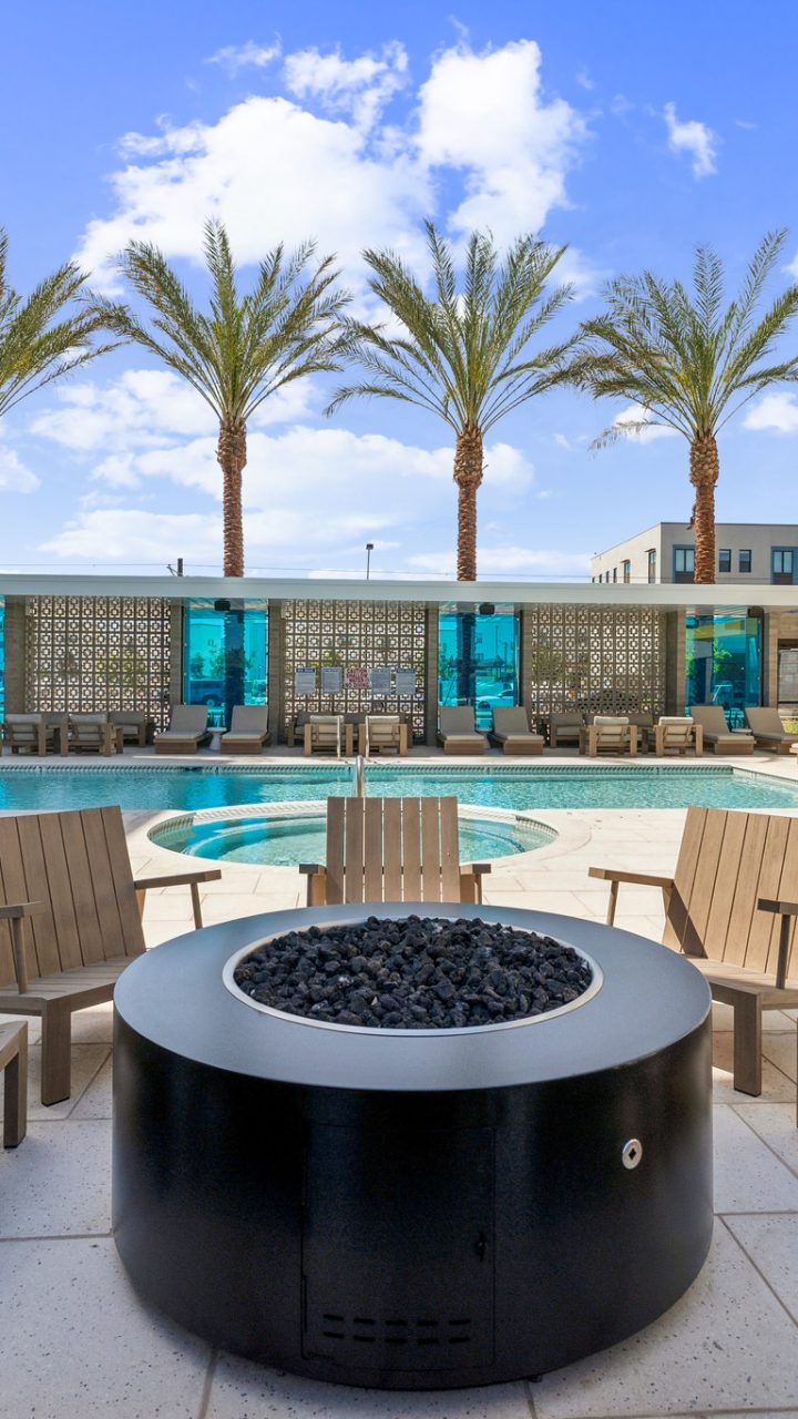 Community firepit and sparkling pool in Blue Eastline's apartment complex