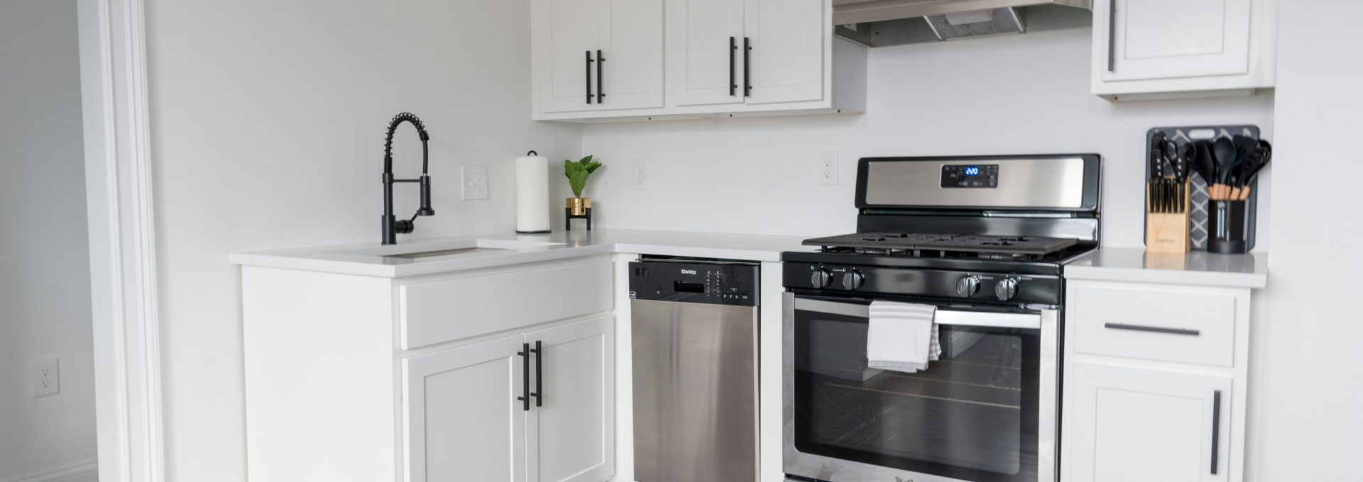 white wooden kitchen cabinet and white microwave oven
