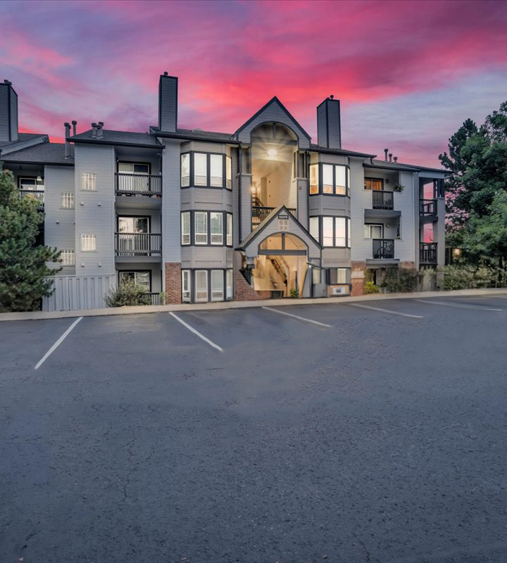 the sunset over an apartment complex in the evening at The Residences at Bear Creek