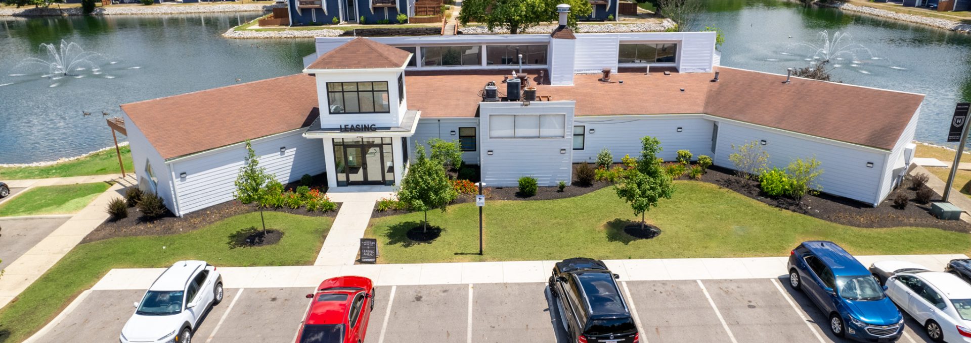 an aerial view of a parking lot with cars at The Lakeshore Cove