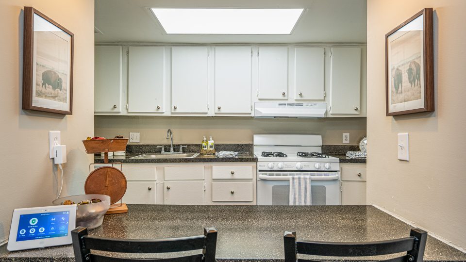 a kitchen with a counter top and a stove at The Lakeshore Cove