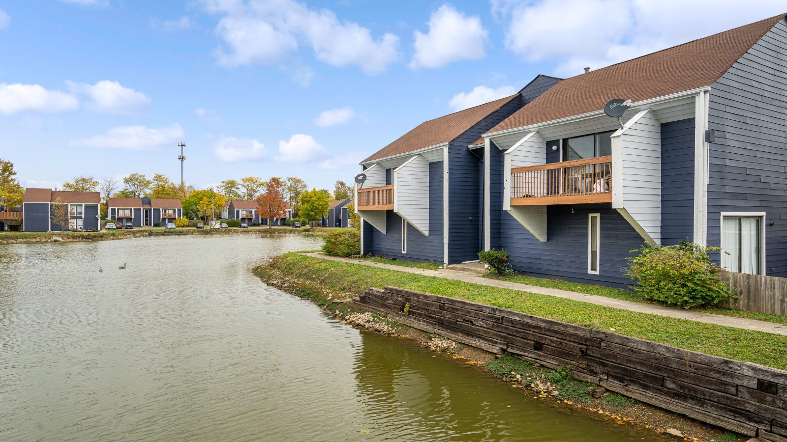 the water is in front of the houses and the water is in the lake at The Lakeshore Cove