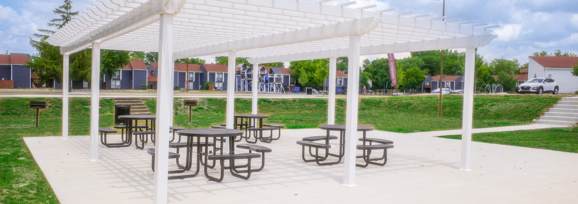 a picnic table and pergol in a park at The Lakeshore Cove