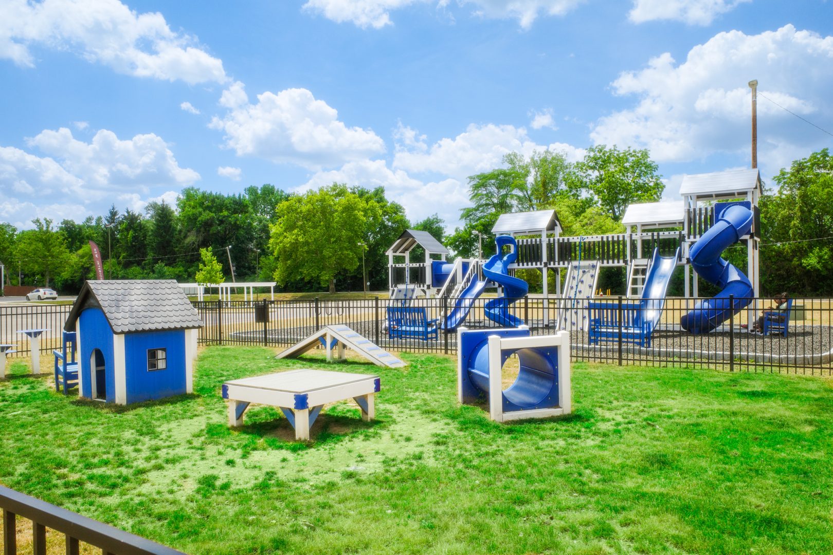 a playground with a slide and a blue slide at The Lakeshore Cove