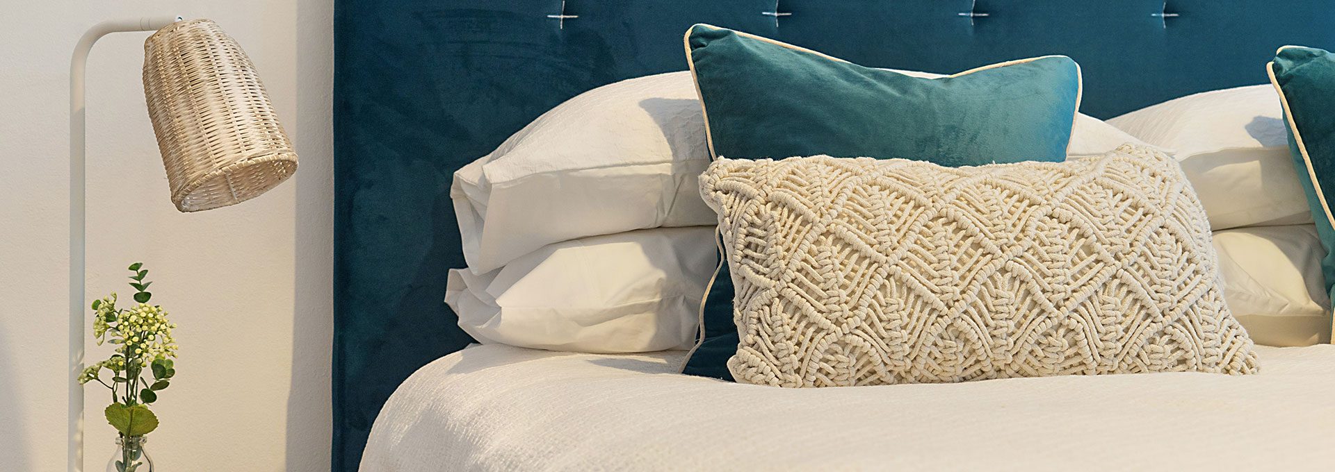 Stock image of a bedroom bed and side table