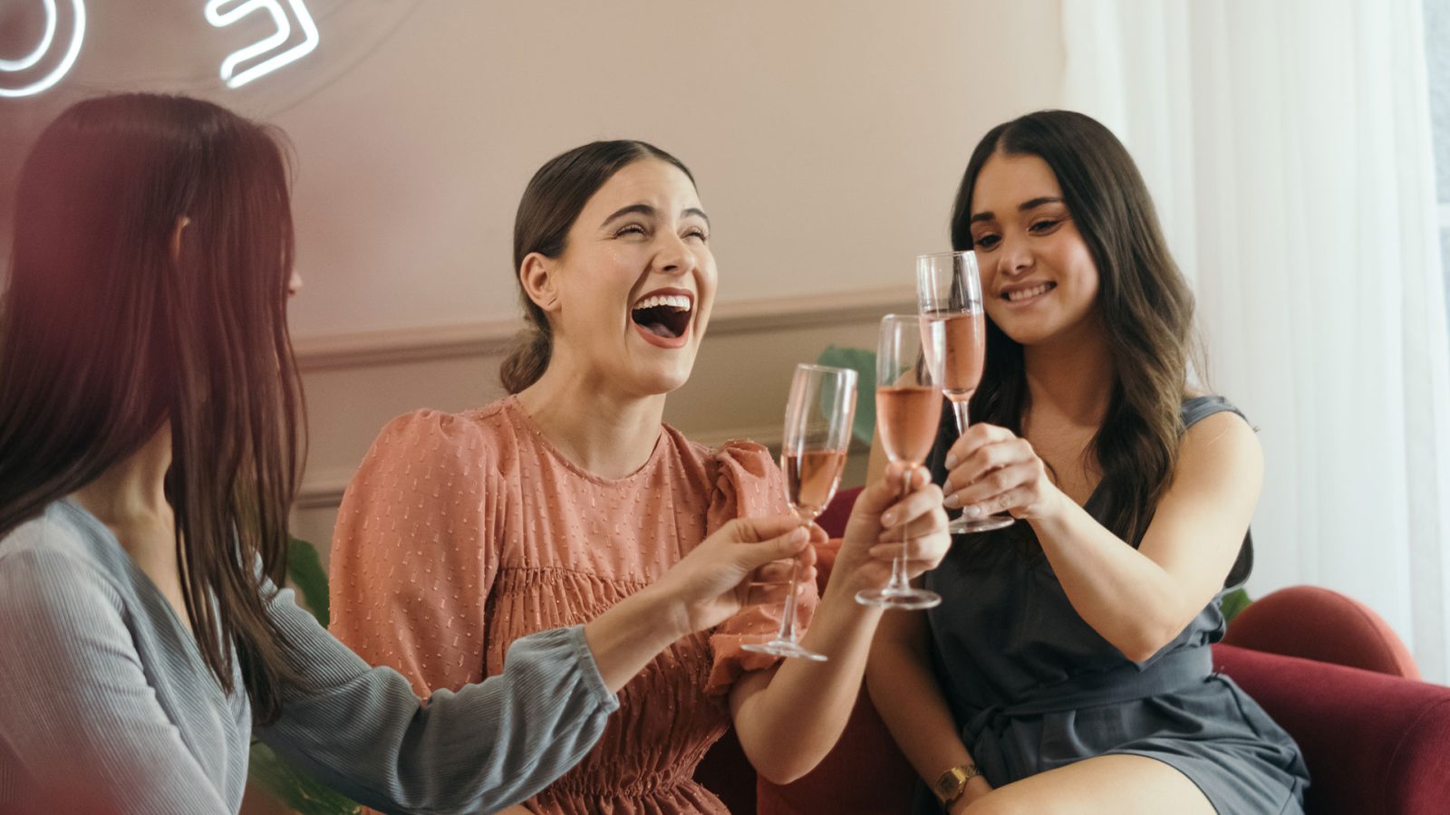 Three women cheersing their champagne glasses