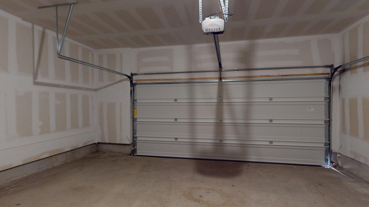 a garage with a door and a light fixture at The Villas at Bardin