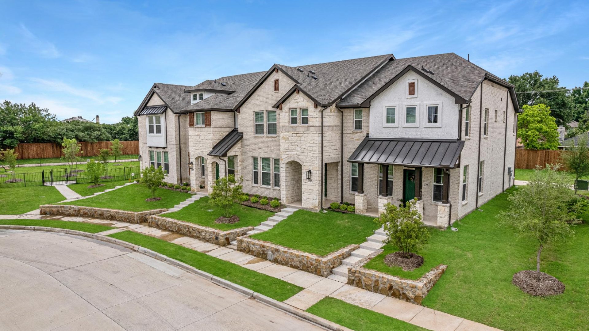 a home in the suburbs with a driveway and grass at The Villas at Bardin