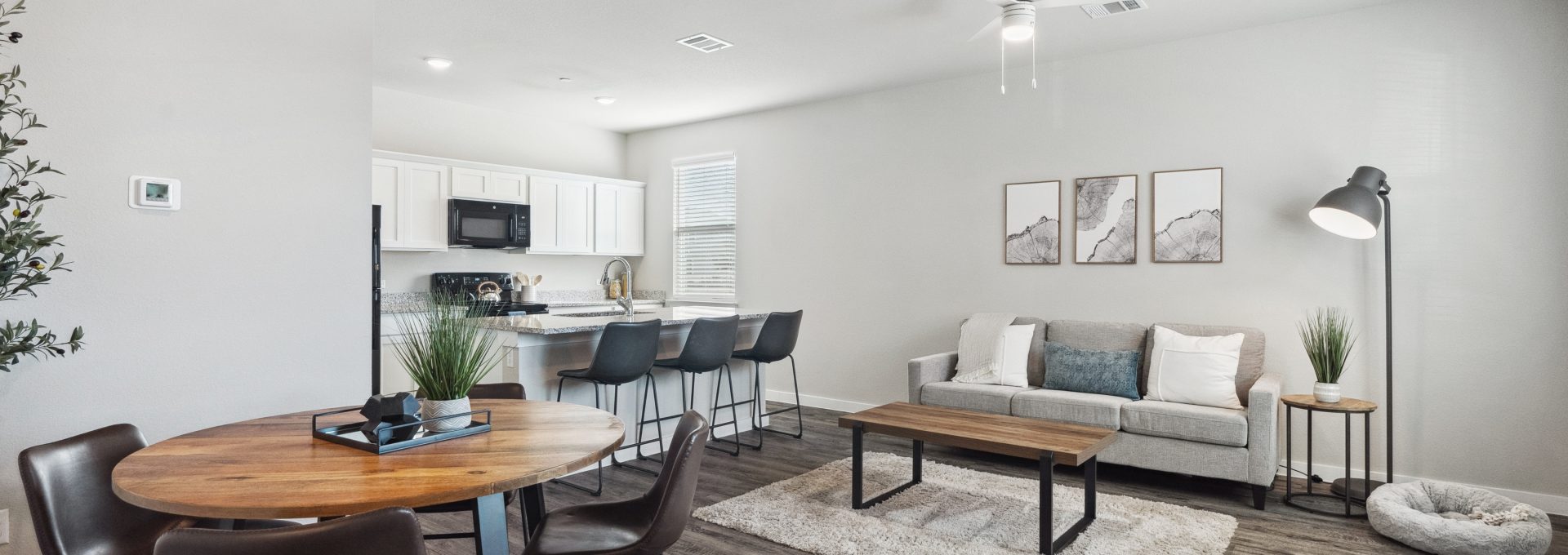 Furnished living room and dining area inside a model townhome at The Powell