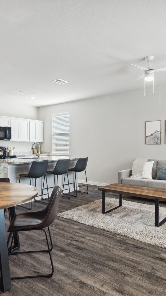 Furnished living room and dining area inside a model townhome at The Powell