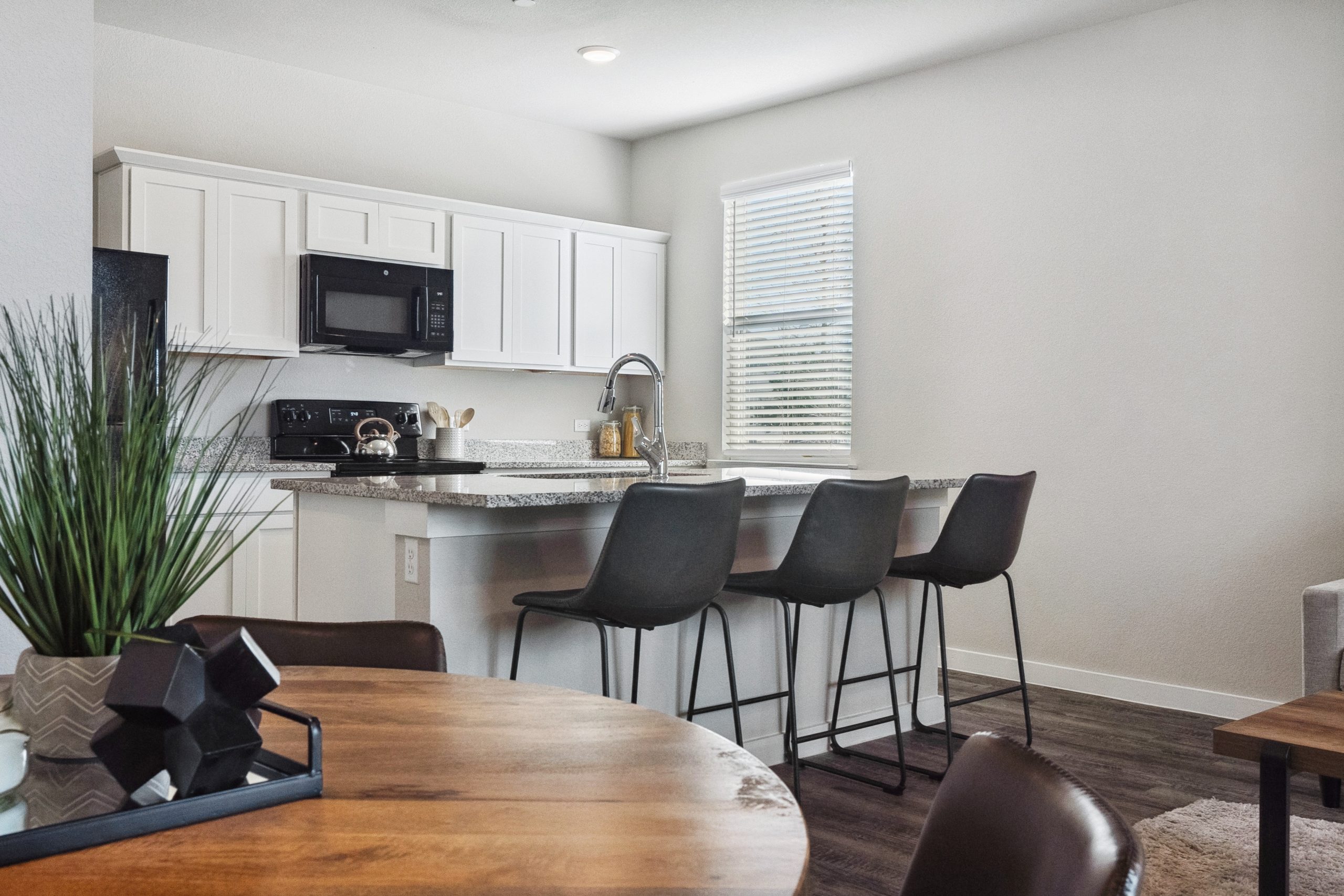 Furnished dining room and kitchen inside a model townhome at The Powell
