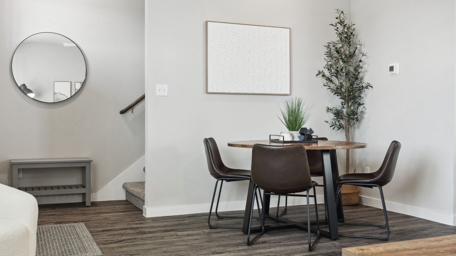 Furnished dining room with a table and chairs inside a model townhome unit at The Powell