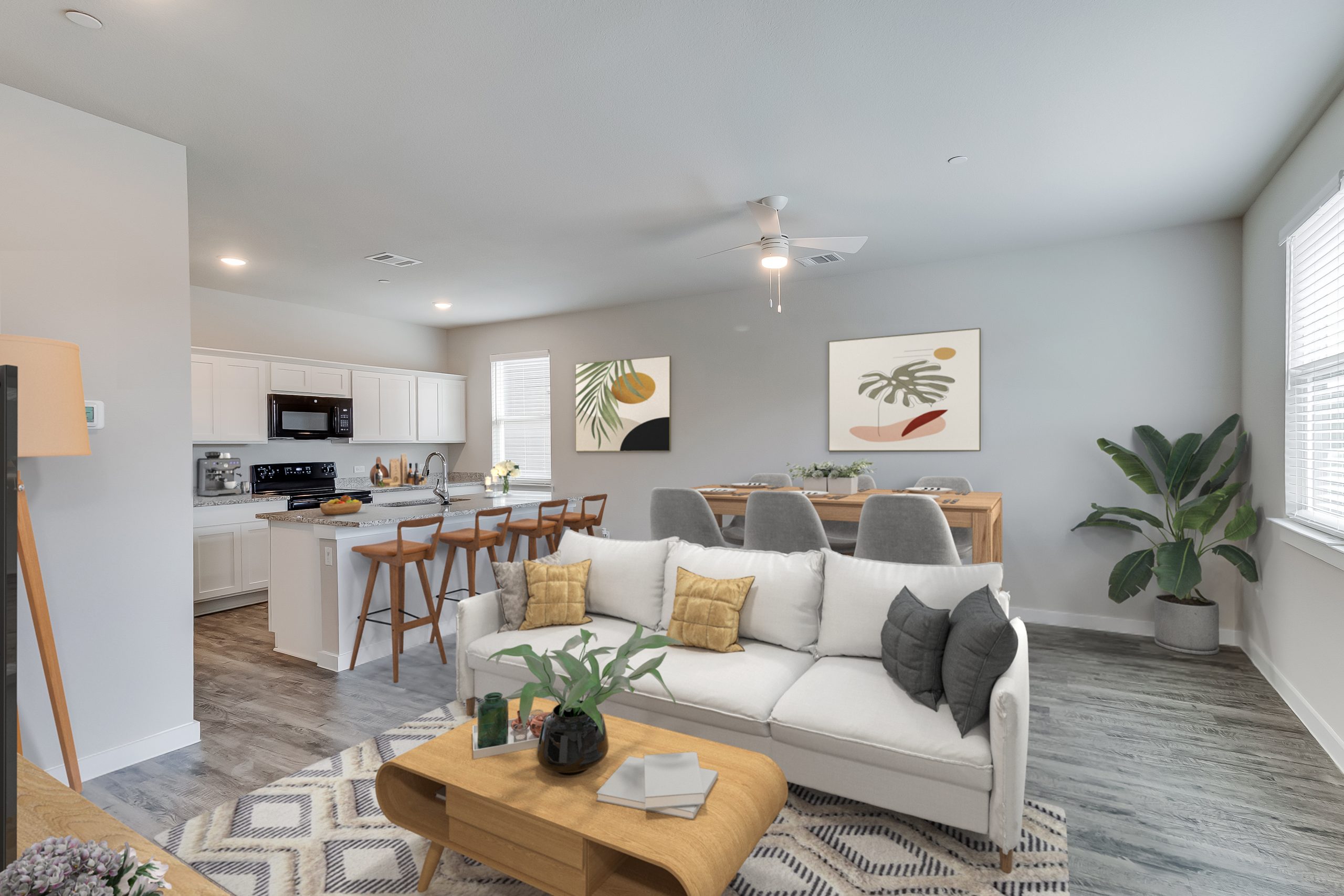 Furnished townhome living room and kitchen area with a couch and coffee table at The Powell