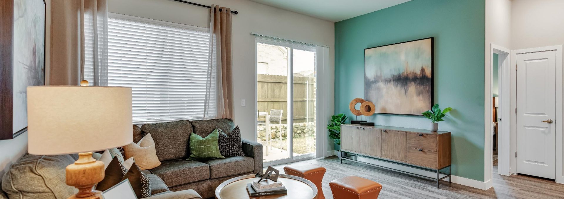 a living room with hardwood floors and a ceiling fan at The VLux Stoneridge