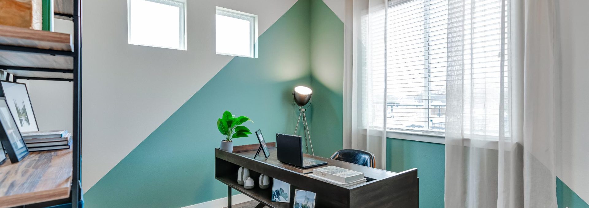 a home office with a desk and a fan at The VLux Stoneridge