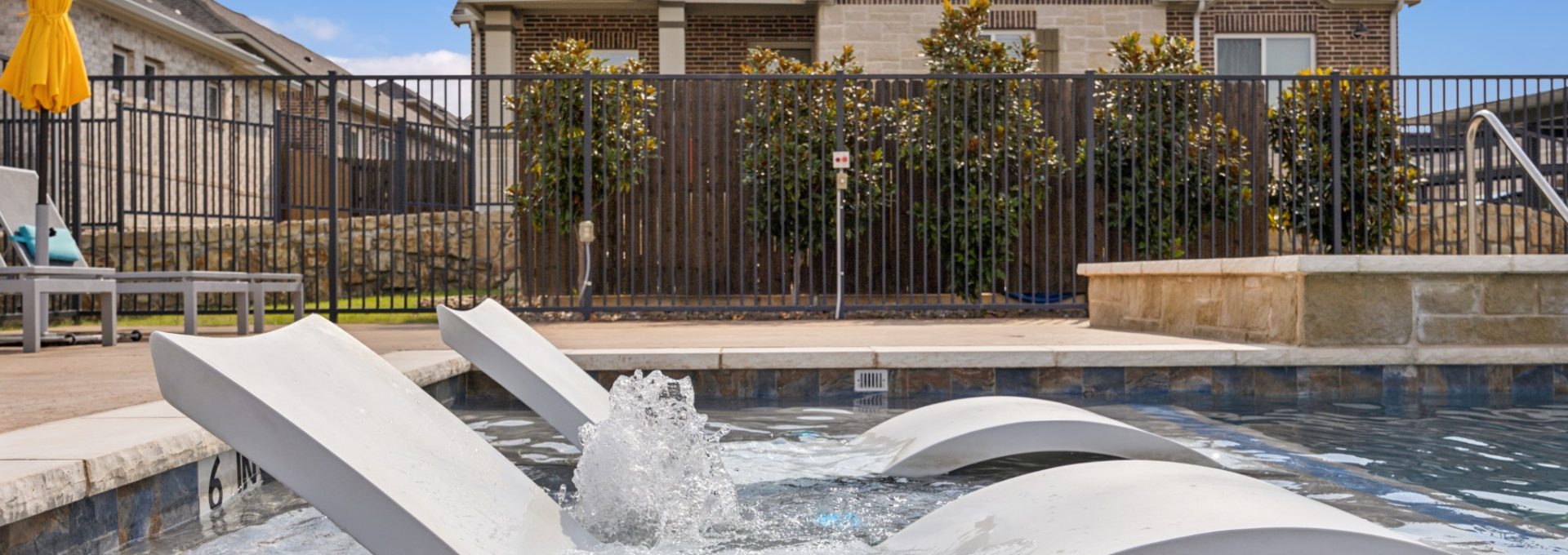 Shelf seating in the community pool at VLux Stoneridge