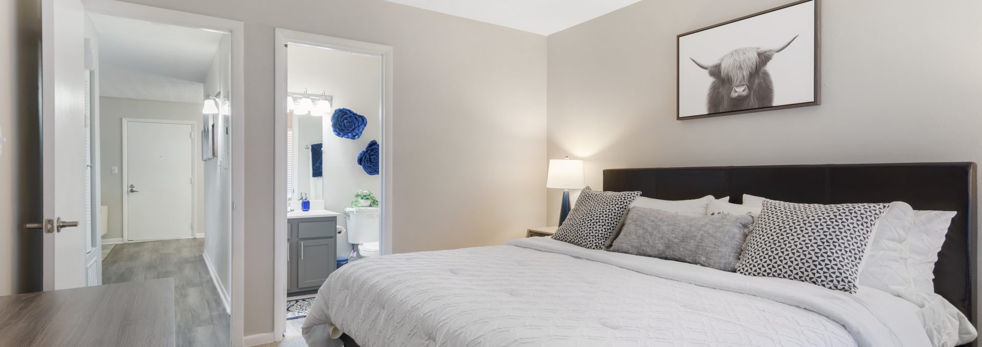 a bedroom with a white bed and a large mirror at The  Wynne