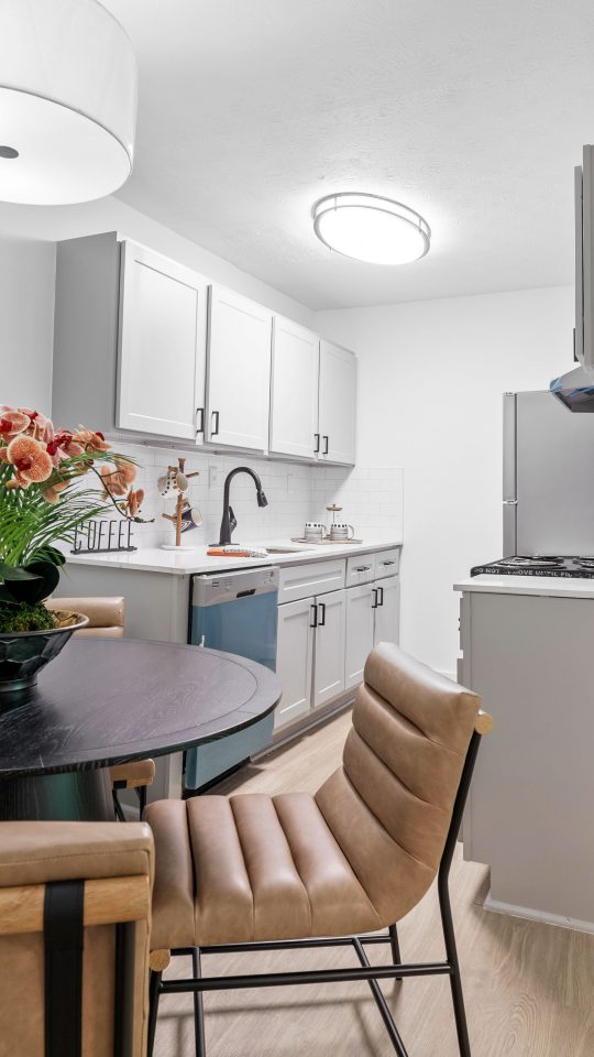 a kitchen and dining room area with a table and chairs at The  Wynne