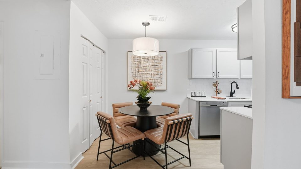 a kitchen with a table and chairs in it