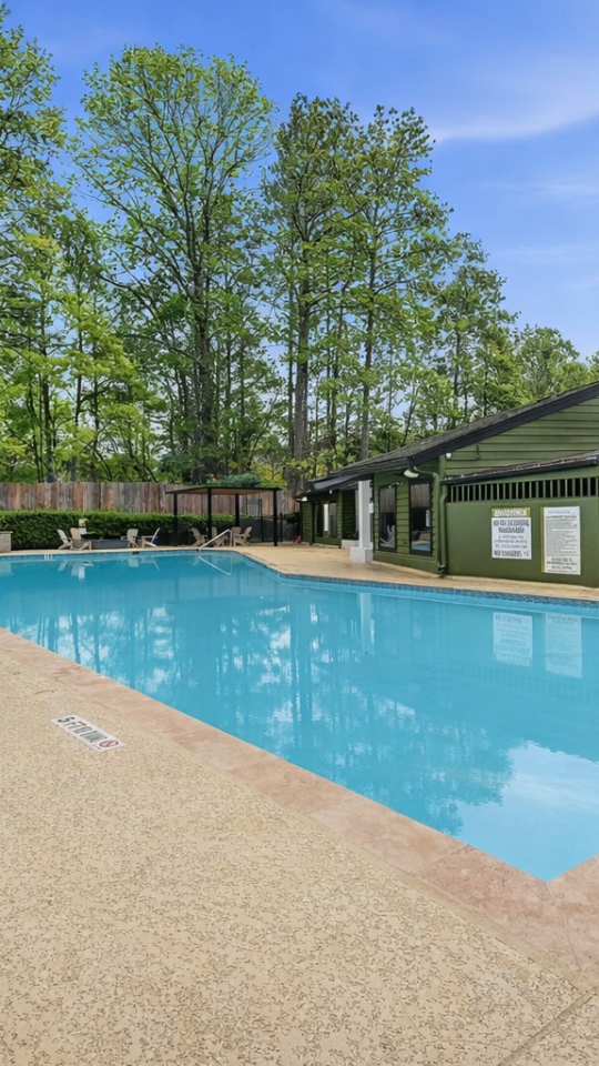 a pool with a pool table and chairs in it