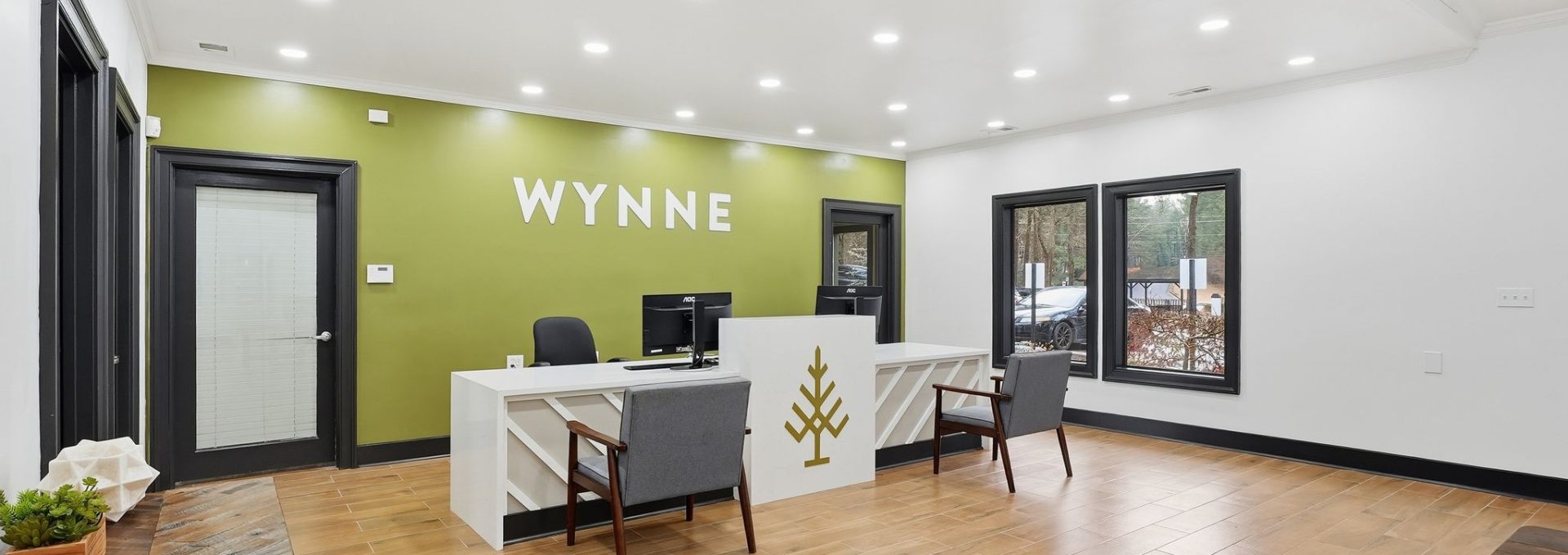 The Wynne leasing office with reception desk, seating and windows to the community