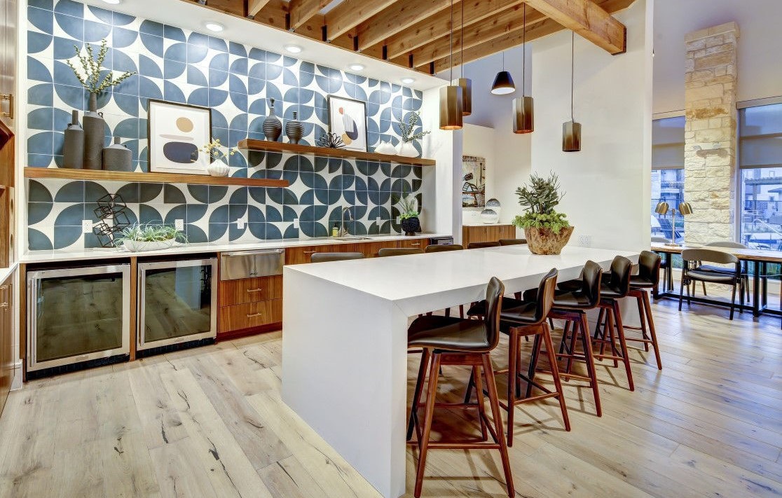 a kitchen with a large island and wood floors at The Conley