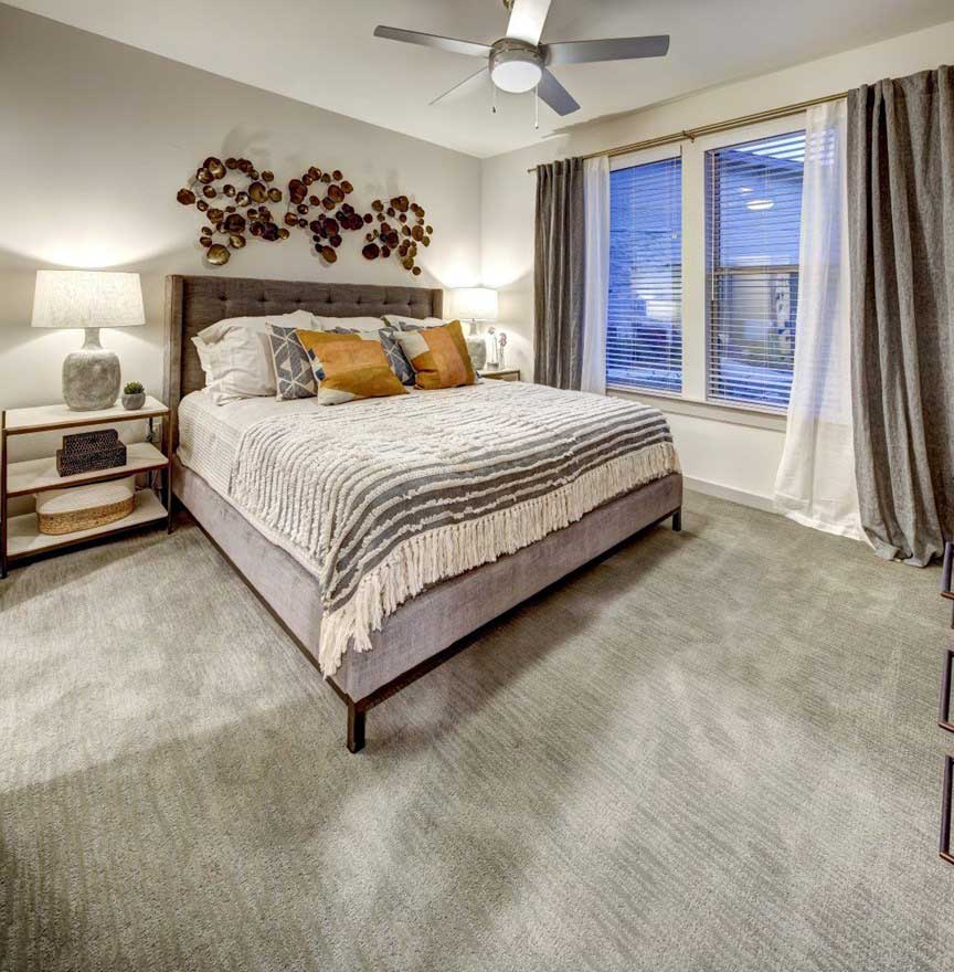 a bedroom with a large bed and ceiling fan at The Conley