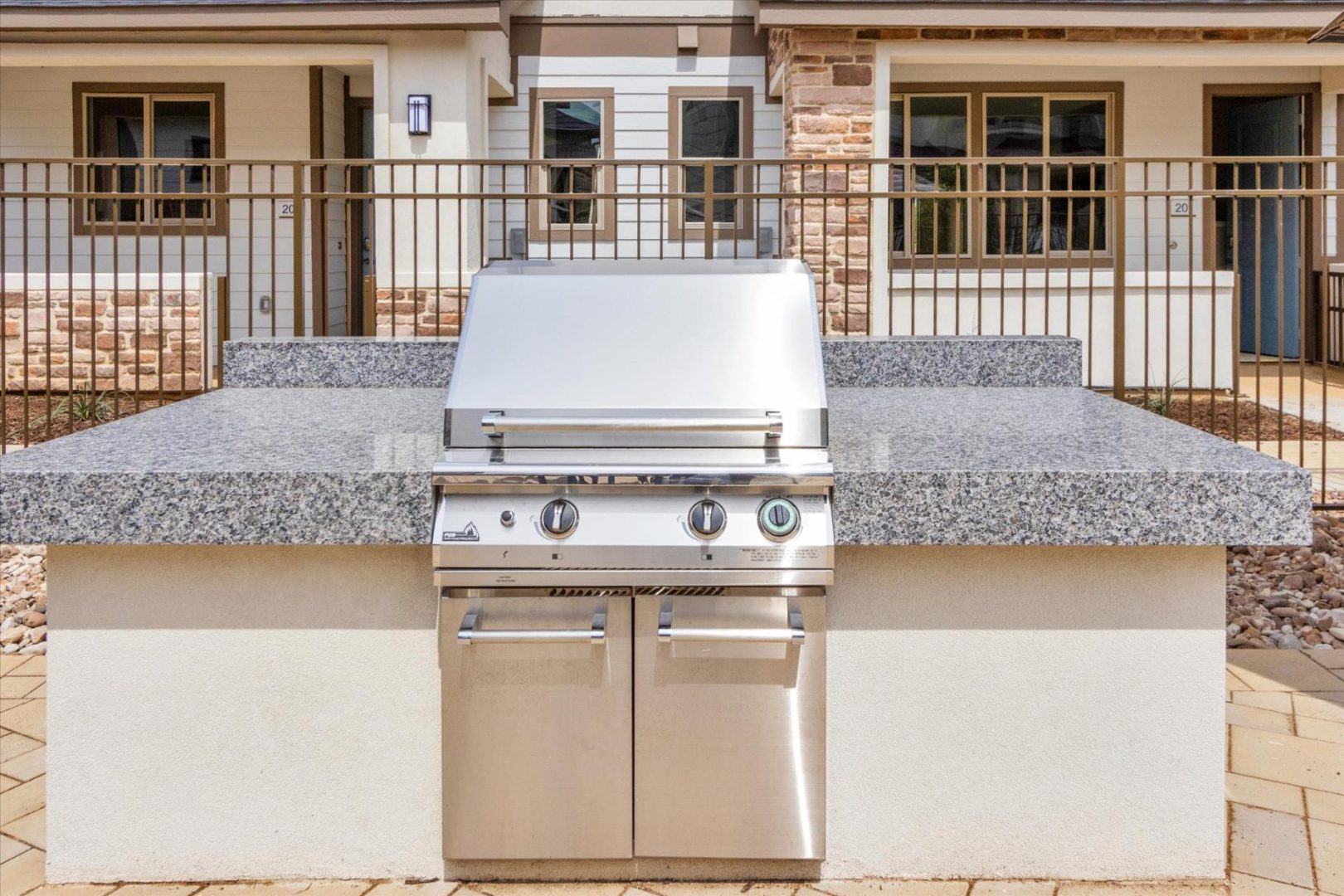 a stainless steel outdoor kitchen with a grill and sink at The Town Arlington