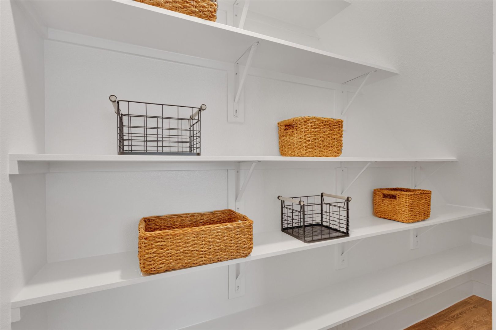 a white closet with baskets and shelves at The Town Arlington