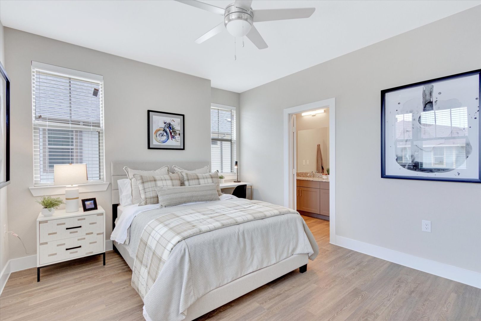 a bedroom with hardwood floors and a ceiling fan at The Town Arlington