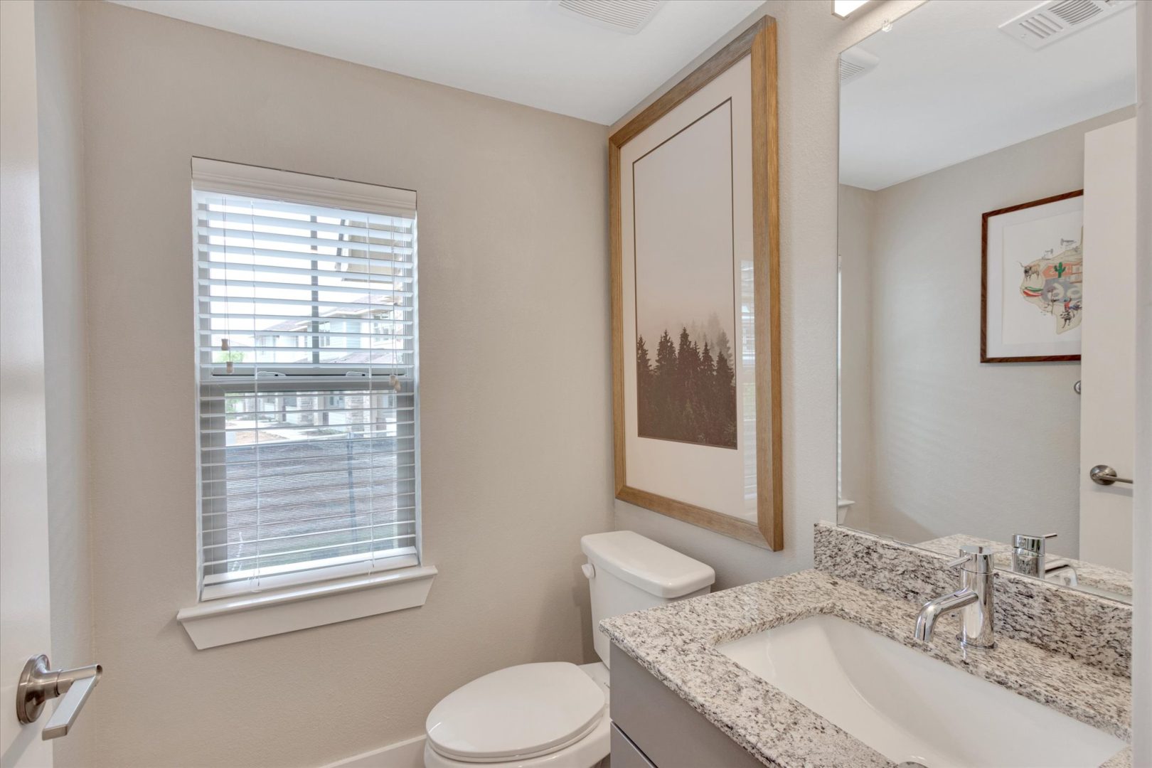 a bathroom with a window and a toilet at The Town Arlington