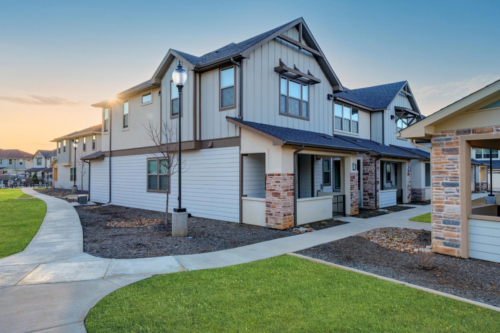 the exterior of a home with a grassy area and a sidewalk at The Town Arlington
