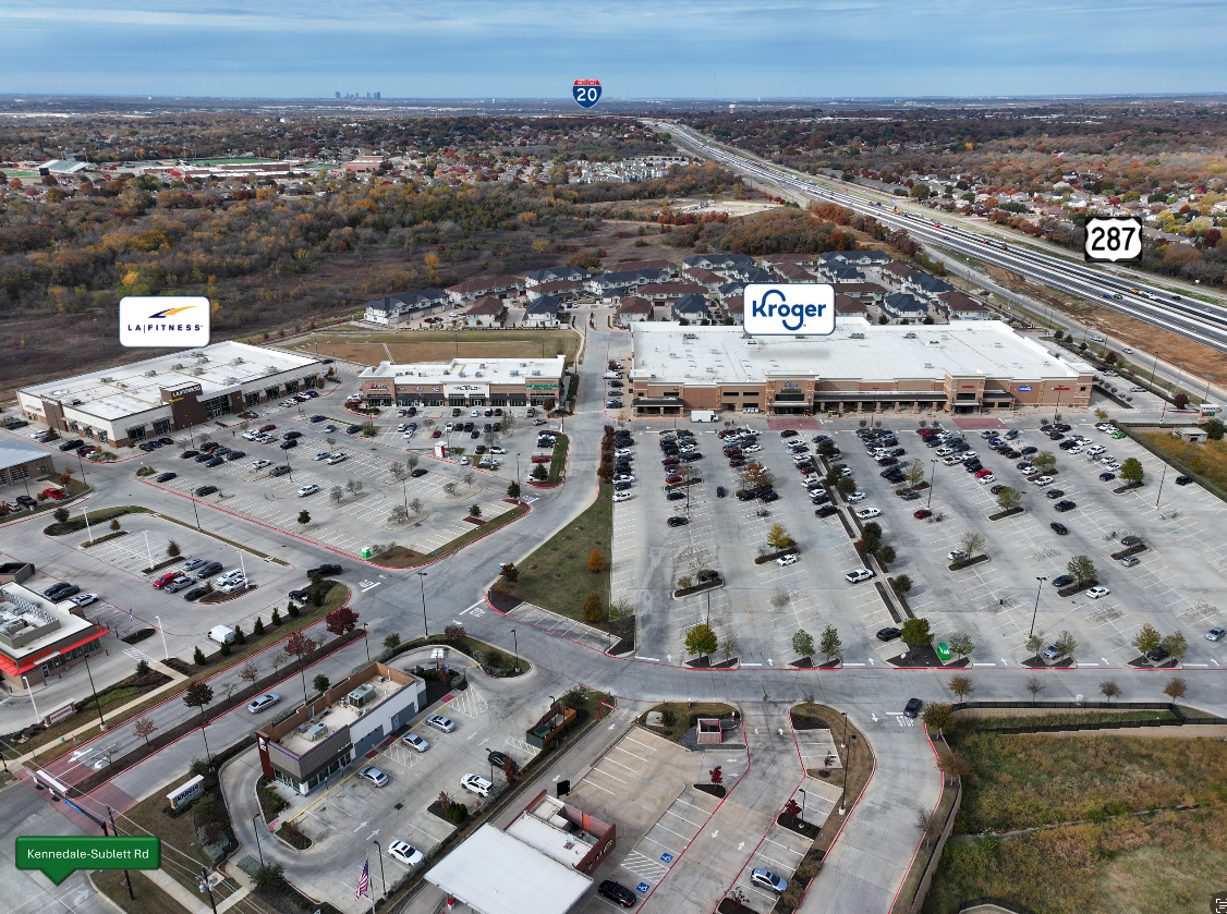 an aerial view of a parking lot and a shopping center at The Town Arlington