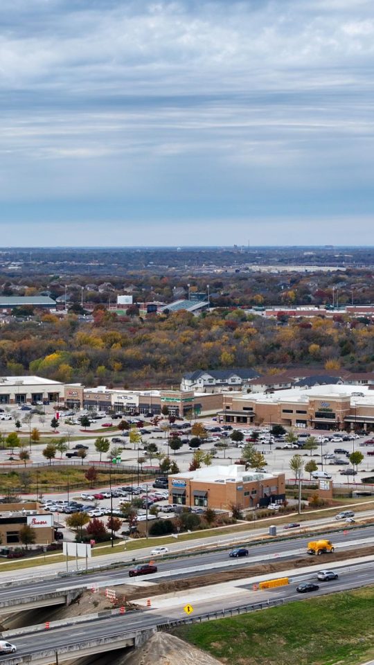 a view of a city from above with a highway in the background at The Town Arlington