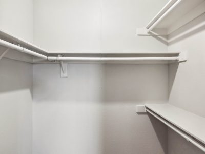 Walk-in closet with built-in shelving in a Country Gables apartment home