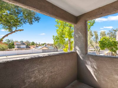 Private covered balcony with neighborhood views at a Country Gables apartment home