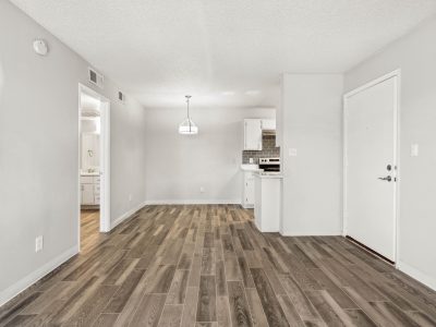 Open-concept living and kitchen area with wood-style flooring at Country Gables