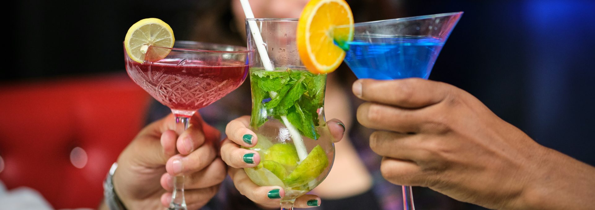 Friends raising glasses for a toast at a happy hour near Country Gables in Glendale, AZ